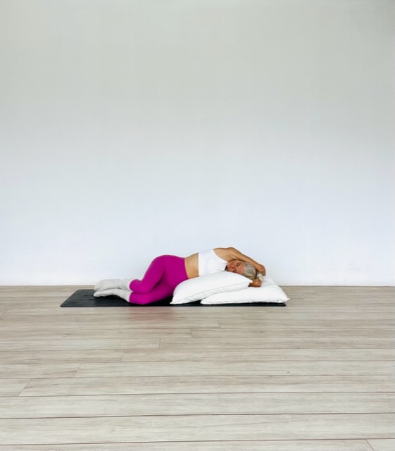 Sleep well restorative yoga practice - reclined side stretch