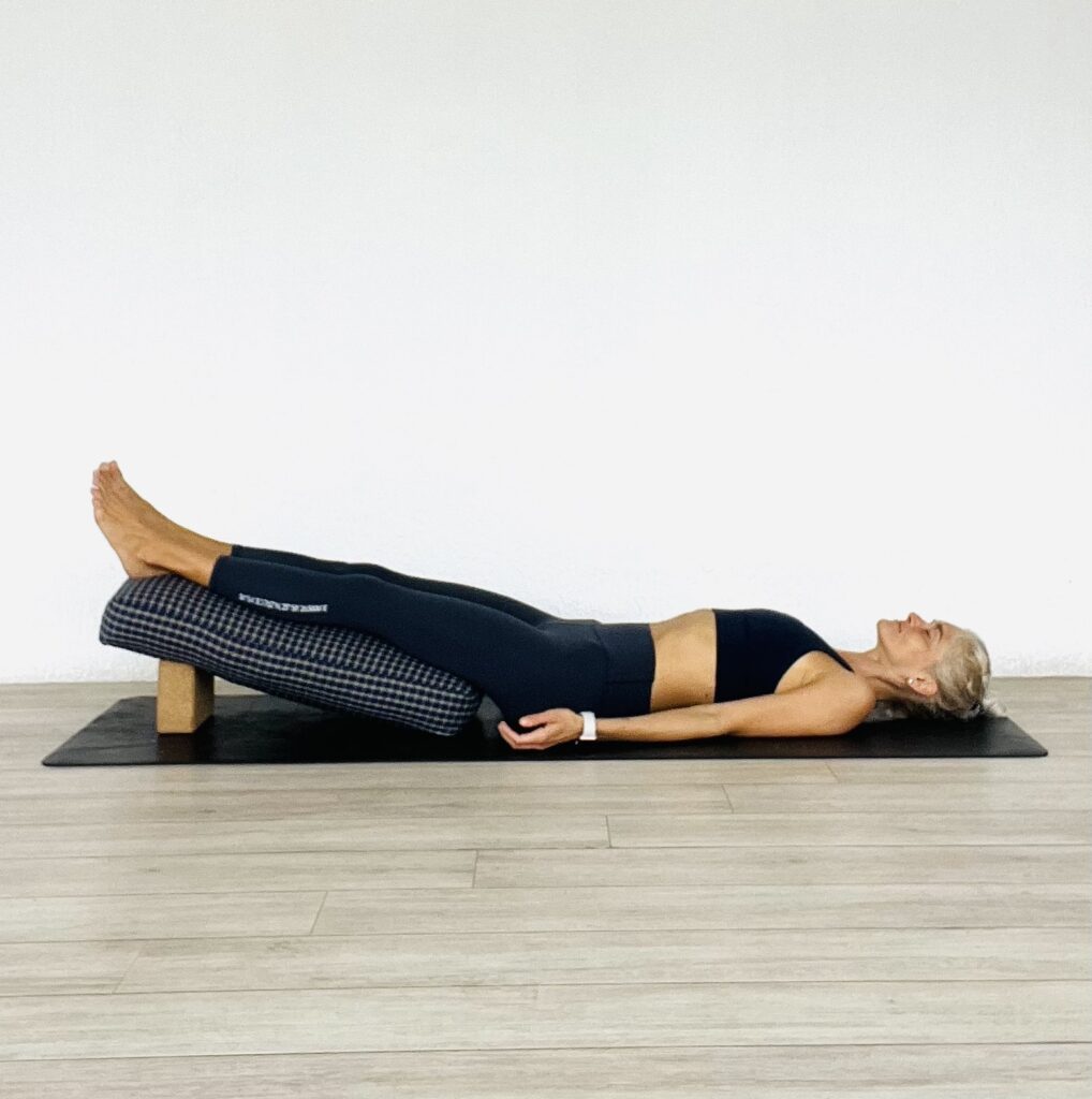 Restorative yoga slight leg raise